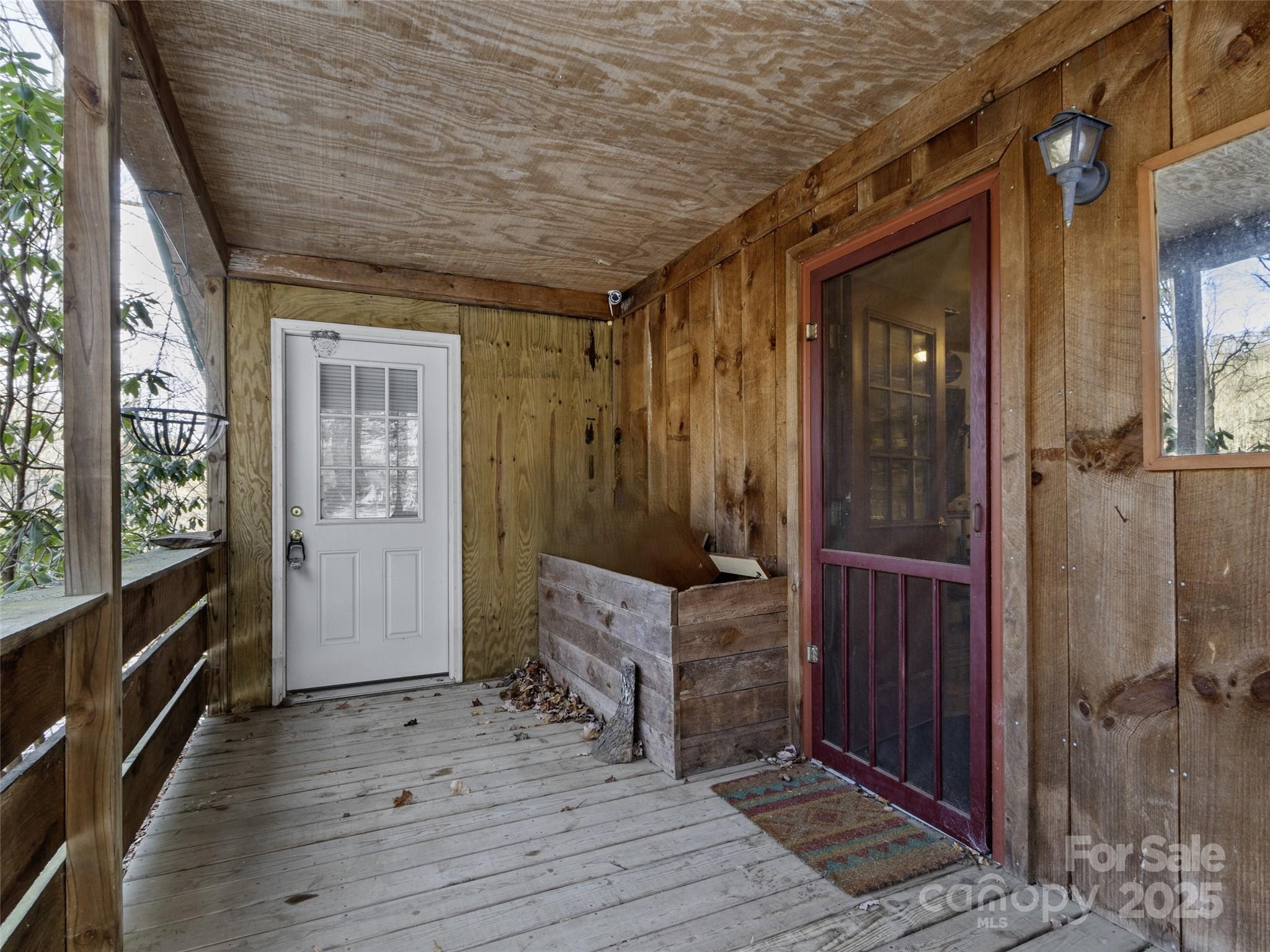 1571 Roaring Fork Road Burnsville, NC 28714 - Photo 15 of 37 a hallway with furniture and wooden floor