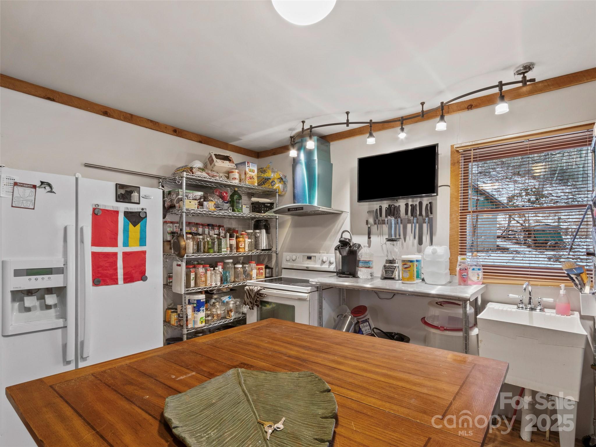 1571 Roaring Fork Road Burnsville, NC 28714 - Photo 20 of 37 a bedroom with furniture and a flat screen tv