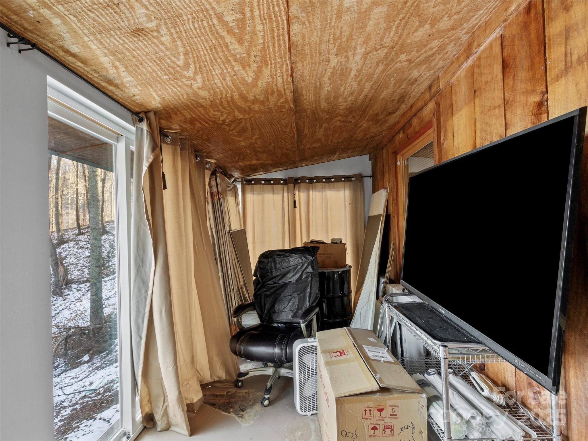 1571 Roaring Fork Road Burnsville, NC 28714 - Photo 36 of 37 a room with furniture and a flat screen tv