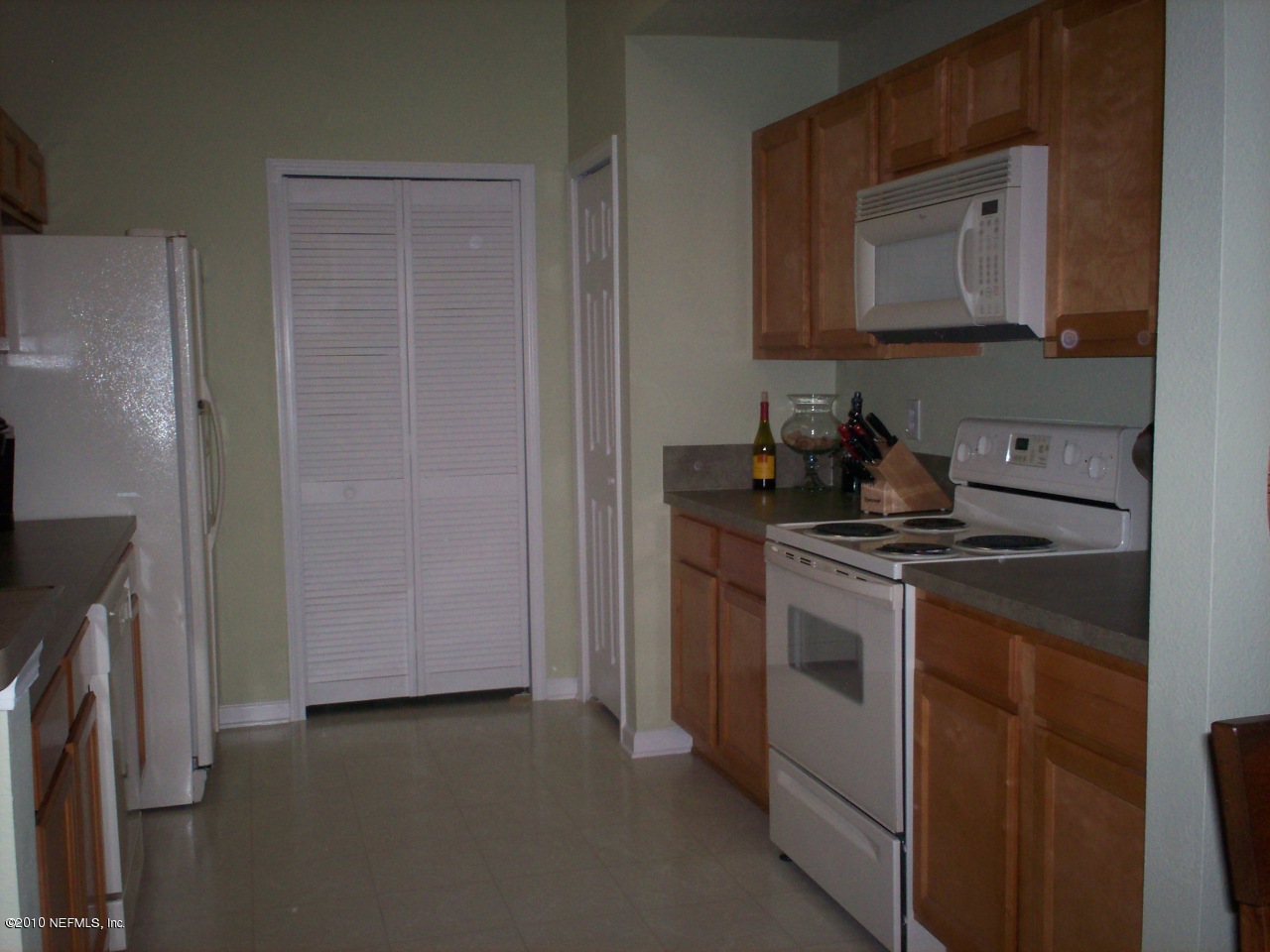 a kitchen with stainless steel appliances granite countertop a stove a refrigerator and a microwave