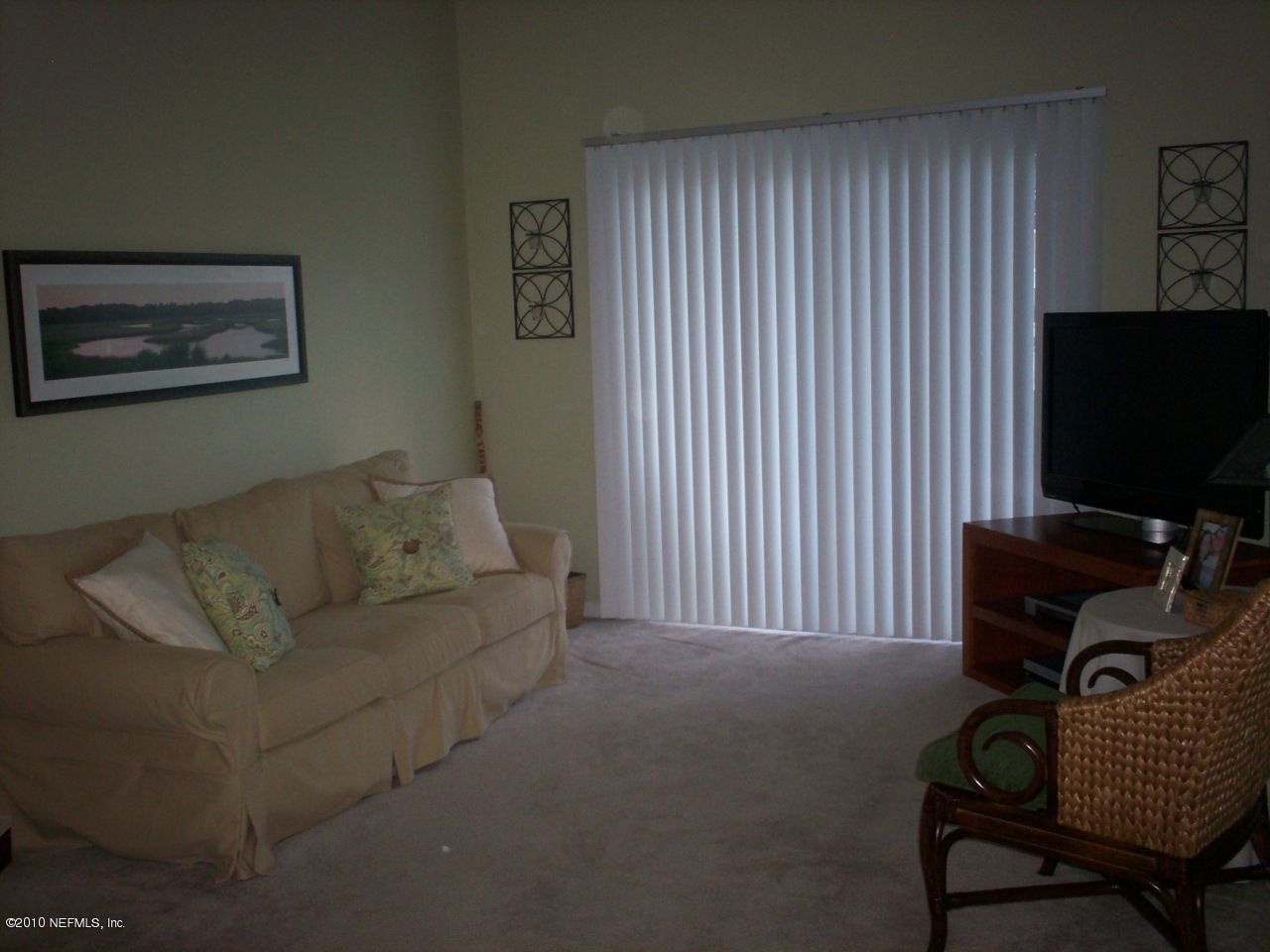 7920 Merrill Road, Unit 2104 Jacksonville, FL 32277 - Photo 2 of 9 a living room with furniture and a flat screen tv