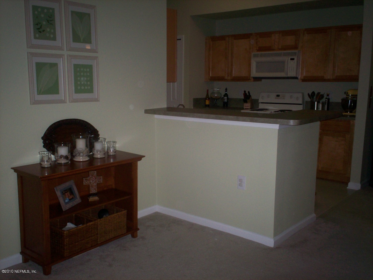 7920 Merrill Road, Unit 2104 Jacksonville, FL 32277 - Photo 5 of 9 a kitchen with a stove and a sink