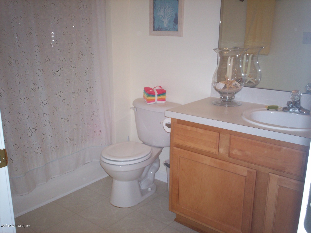 7920 Merrill Road, Unit 2104 Jacksonville, FL 32277 - Photo 9 of 9 a bathroom with a toilet sink and mirror
