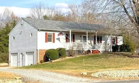 a front view of a house with swimming pool and glass windows
