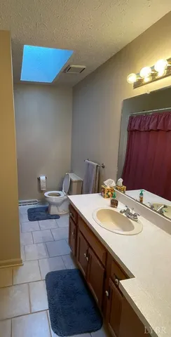 a spacious bathroom with a sink and a mirror
