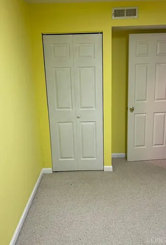 an empty room with wooden door