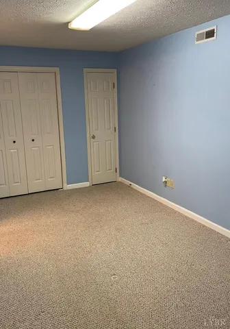 a view of an empty room and entryway