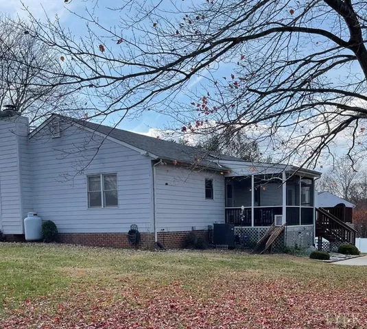 a view of a backyard with large trees