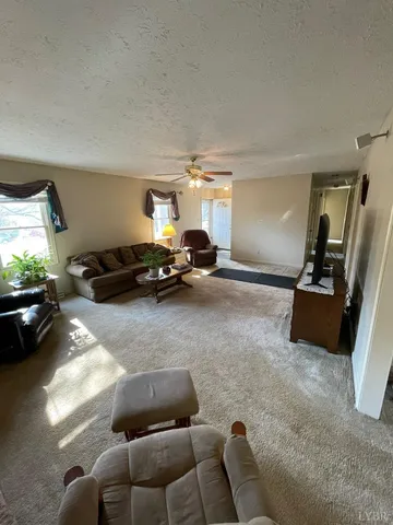 a living room with furniture gym equipment and a large window