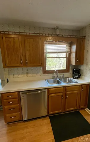 a kitchen with stainless steel appliances granite countertop a sink and a stove