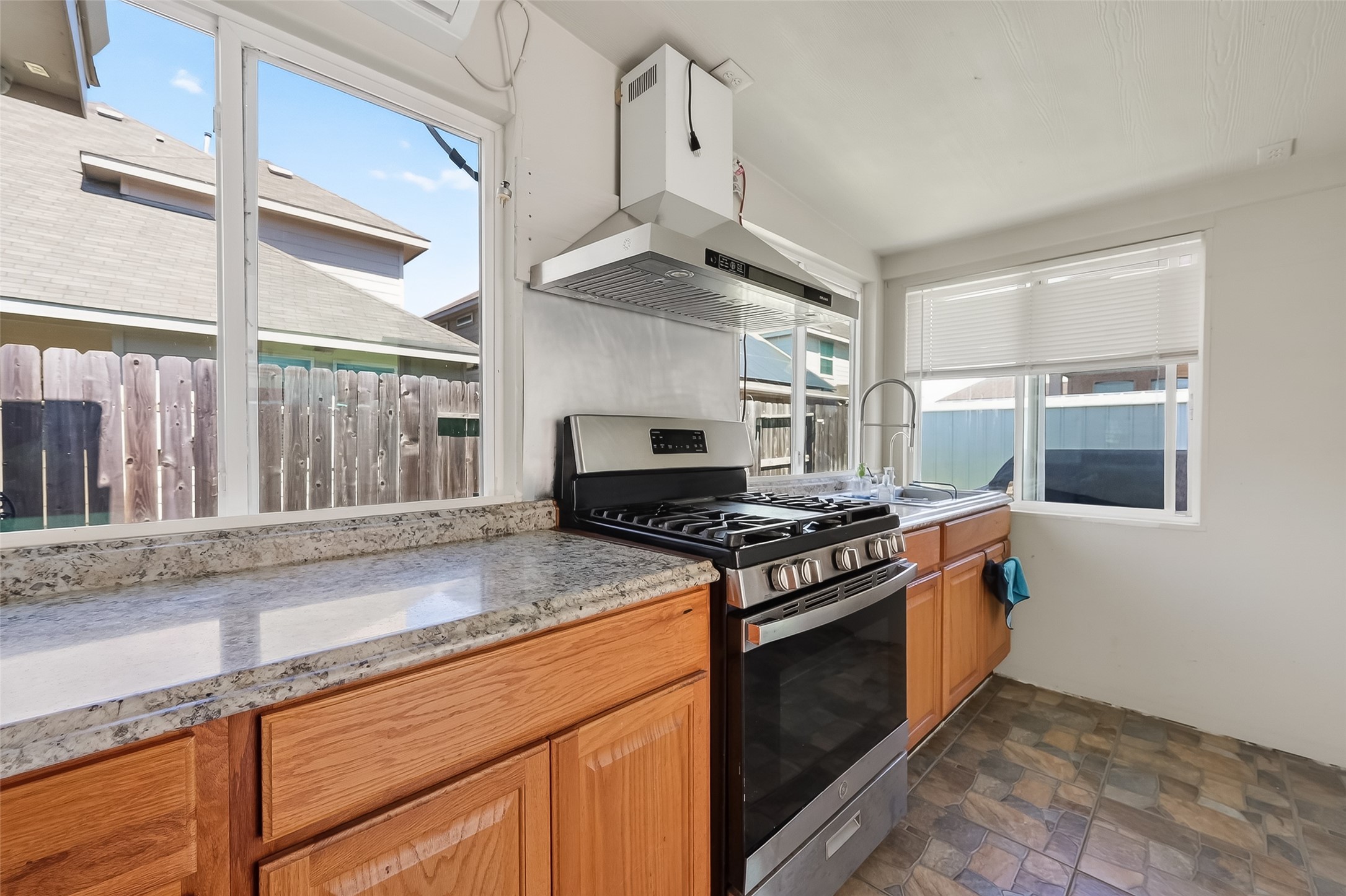 7631 Granite Terrace Lane Houston, TX 77083 - Photo 14 of 46 a kitchen with stainless steel appliances granite countertop a stove and a sink
