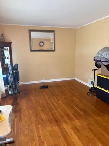 a view of a room with wooden floor and chair