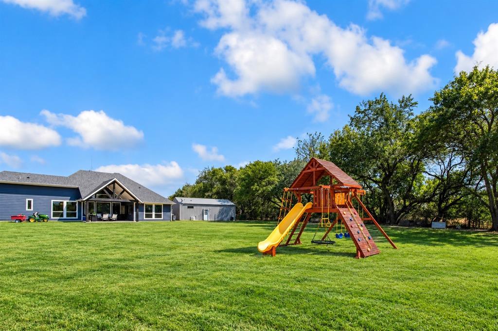 475 Massey Road Gunter, TX 75058 - Photo 7 of 34 Expansive green lawn with mature trees and a detached structure