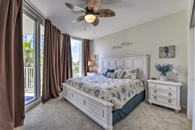a bedroom with a bed a dresser and a chandelier