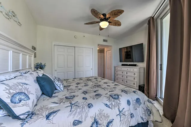a bedroom with a bed and a flat screen tv