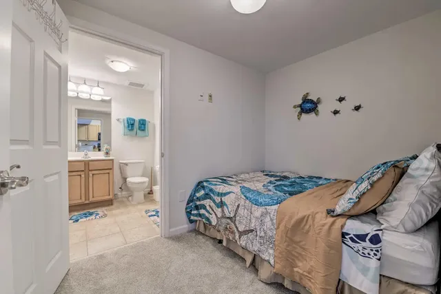 a bedroom with a bed and a view of bathroom