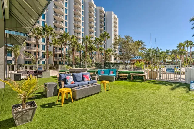 a view of a swimming pool with a bench and lawn chairs