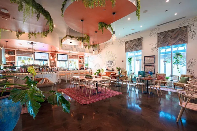 a living room with lots of furniture and a floor to ceiling window