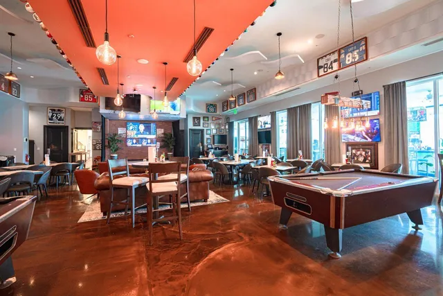 a living room with lots of furniture and a large window