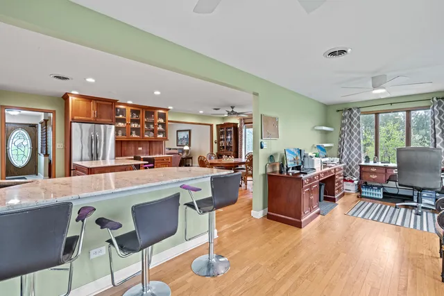 a living room with furniture a fireplace and a large window