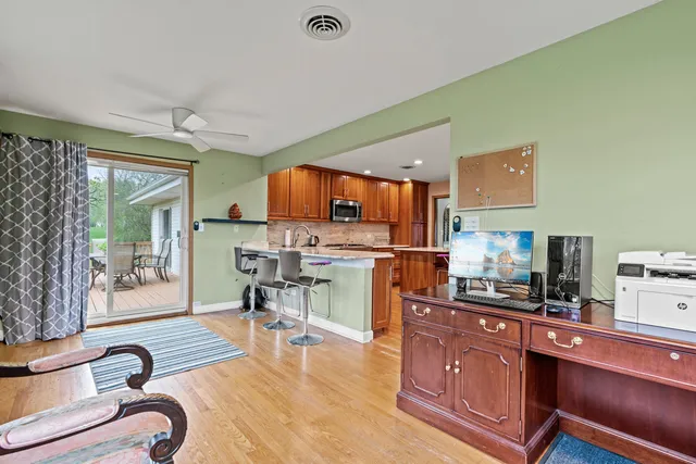 a kitchen with stainless steel appliances kitchen island granite countertop a stove top oven a sink a counter space and cabinets