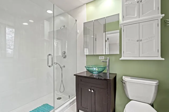 a bathroom with a toilet shower and sink