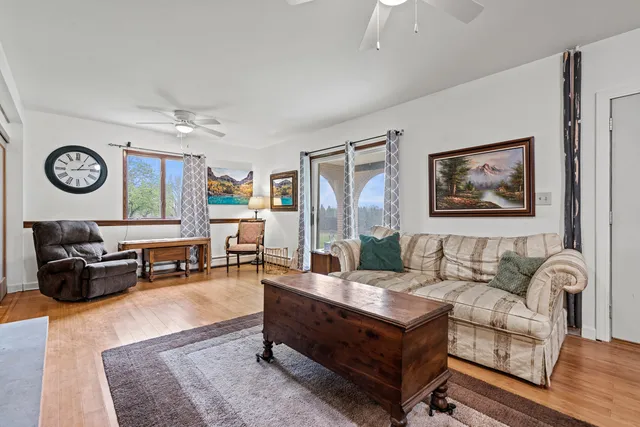 a living room with furniture and wooden floor