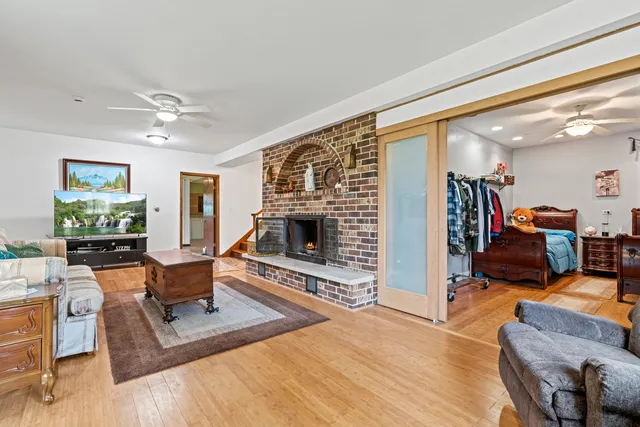 a living room with furniture a fireplace and a flat screen tv