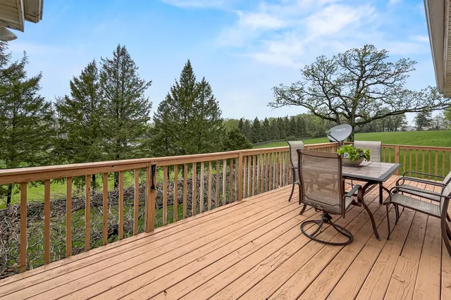 a view of a deck with table and chairs and wooden floor