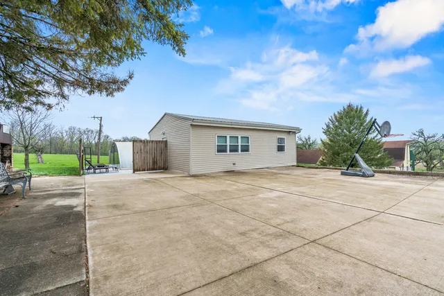 a backyard of a house with outdoor seating
