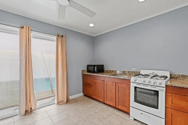 a backyard of a house with table and chairs