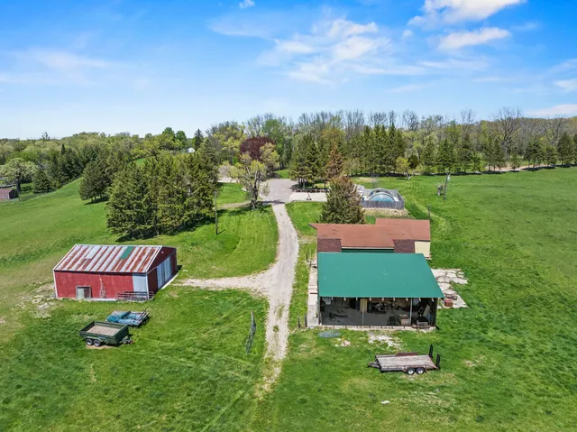 an aerial view of a house with big yard