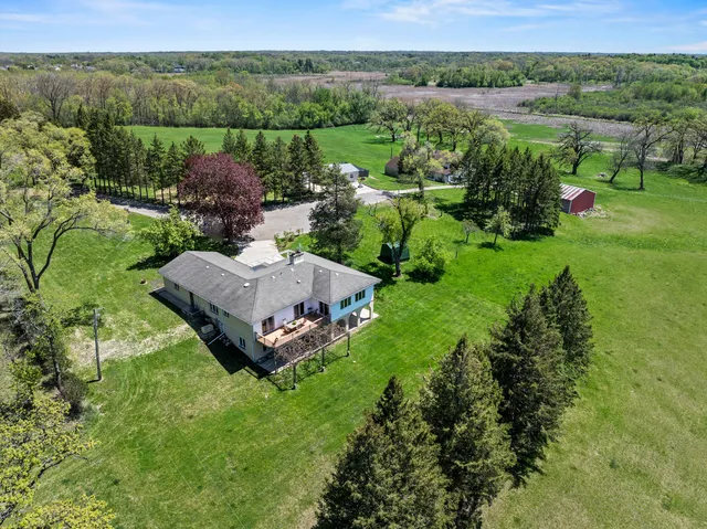 a view of a backyard with table and chairs with wooden fence