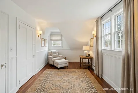 a bedroom with furniture and a window