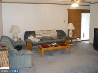 67 Granite Road Levittown, PA 19057 - Photo 4 of 6 a living room with furniture and a chandelier