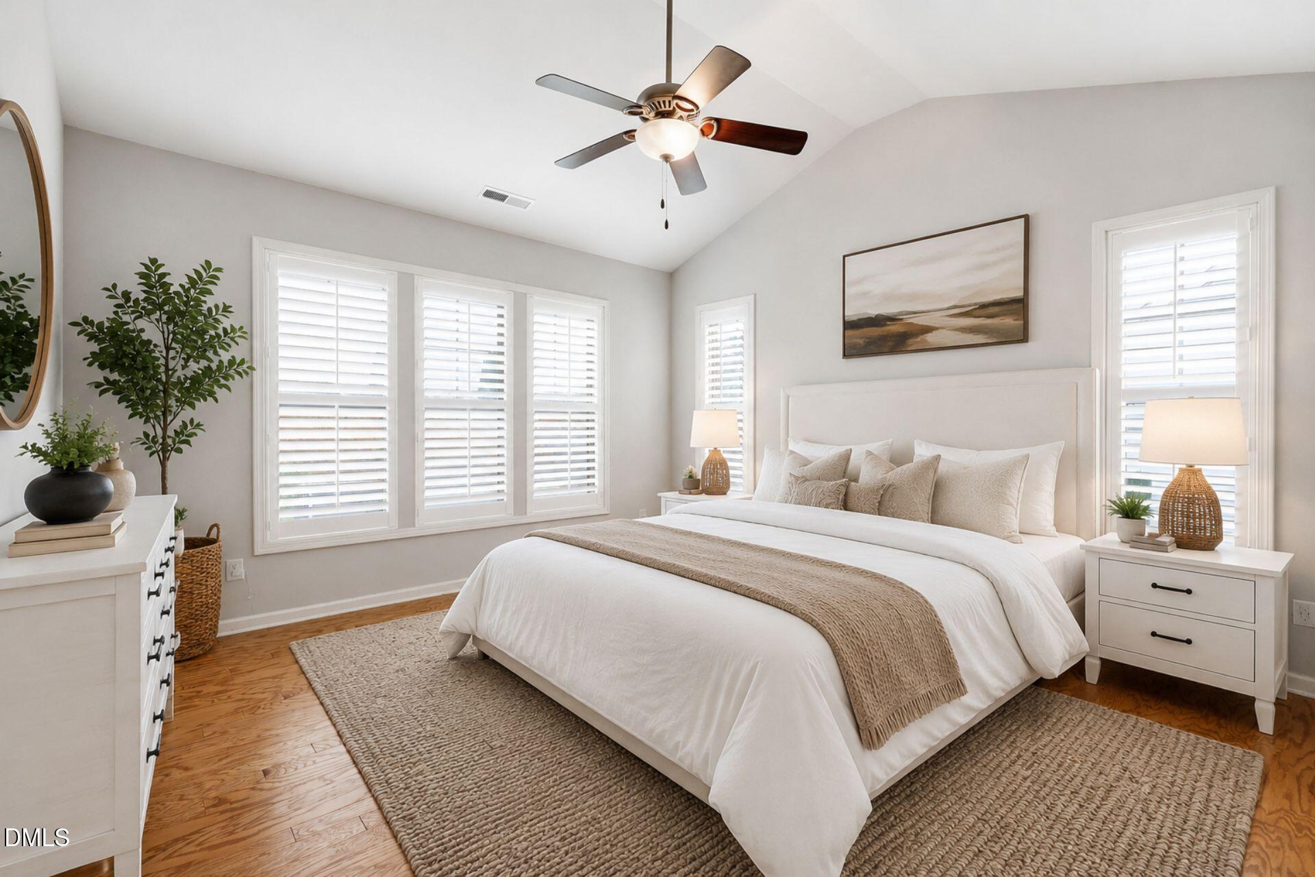 522 Brunello Drive Wake Forest, NC 27587 - Photo 8 of 24 a spacious bedroom with a bed and a chandelier