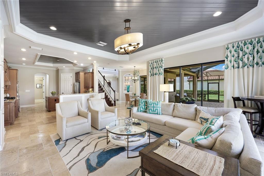 9856 Corso Bello Drive Naples, FL 34113 - Photo 1 of 50 a living room with furniture and a large window