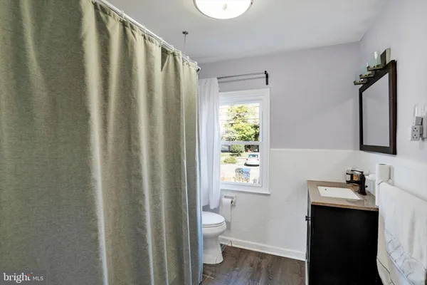 a bathroom with a toilet a sink and a mirror
