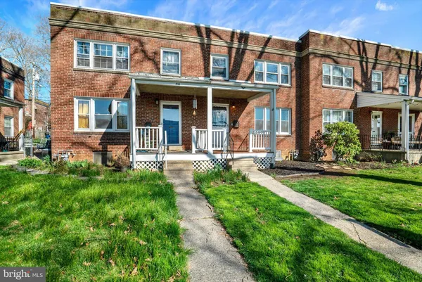 front view of a brick building with a yard