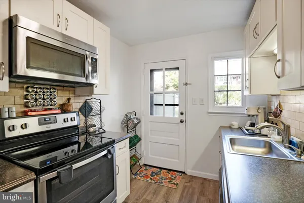 a kitchen with a stove and a microwave