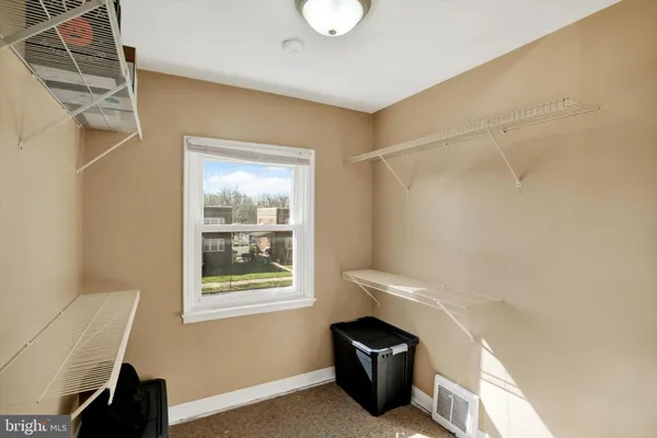 a bathroom with a toilet a sink and a window