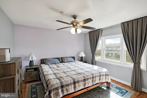 a bedroom with a bed dresser and a window