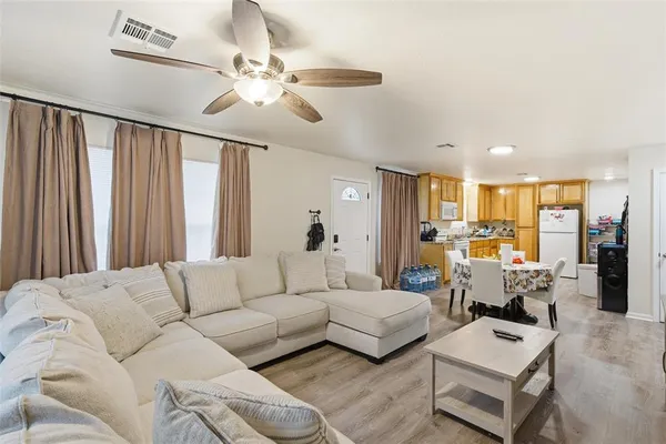 a living room with furniture and a chandelier