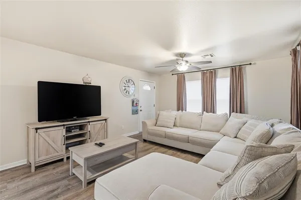 a living room with furniture and a flat screen tv