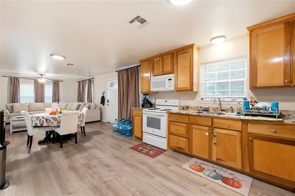 a large white kitchen with stainless steel appliances