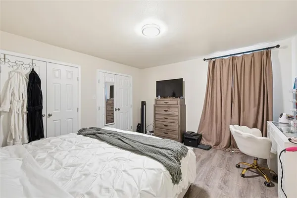 a bedroom with a bed and a television