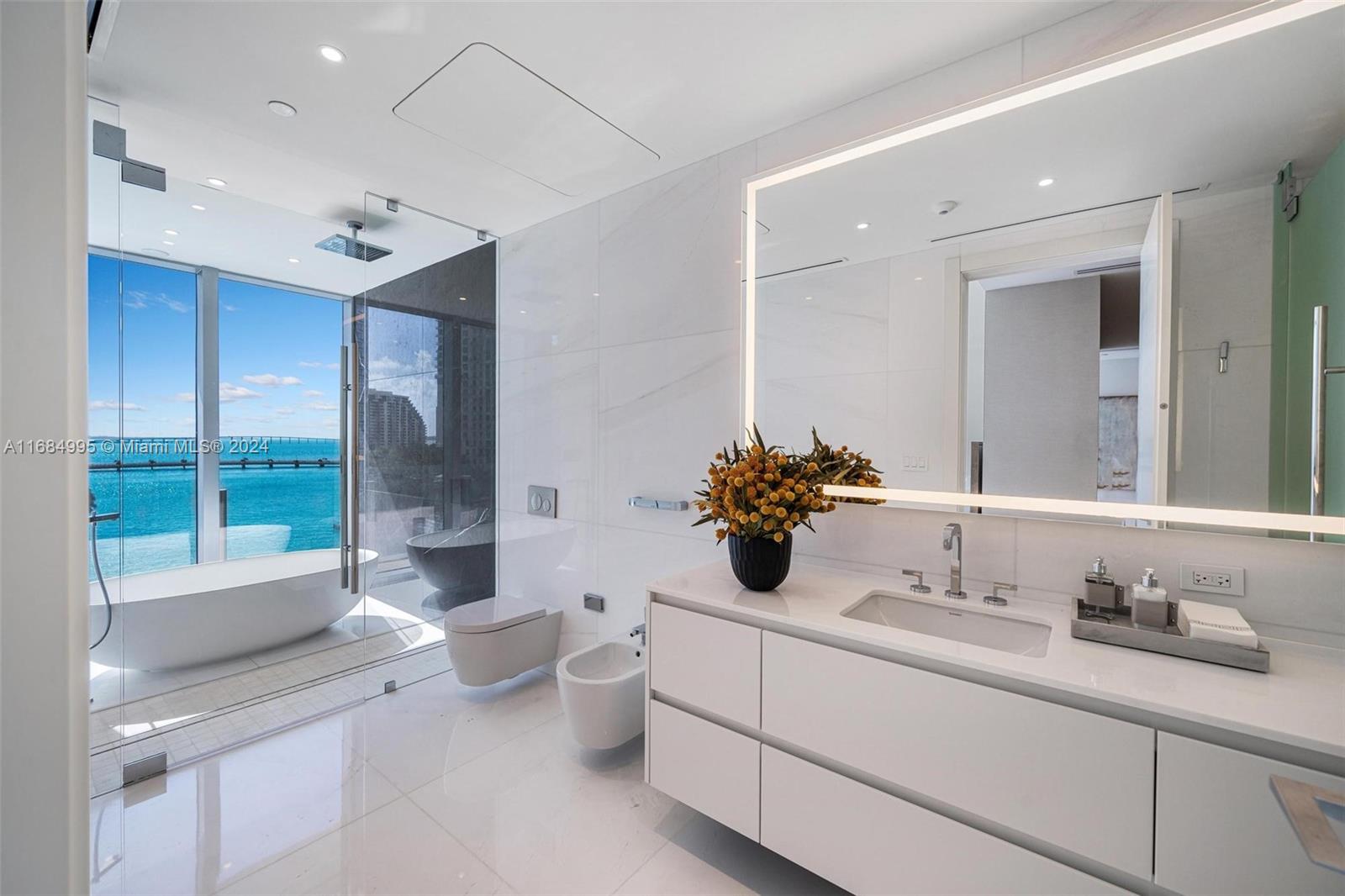 300 Biscayne Blvd Way, Unit 701 Miami, FL 33131 - Photo 16 of 37 a bathroom with a sink and a large mirror