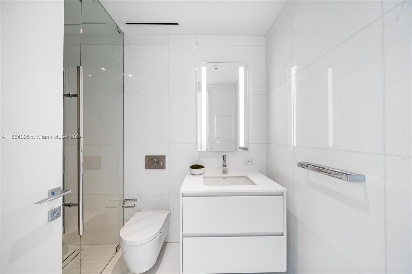 300 Biscayne Blvd Way, Unit 701 Miami, FL 33131 - Photo 20 of 37 a bathroom with a sink toilet and shower