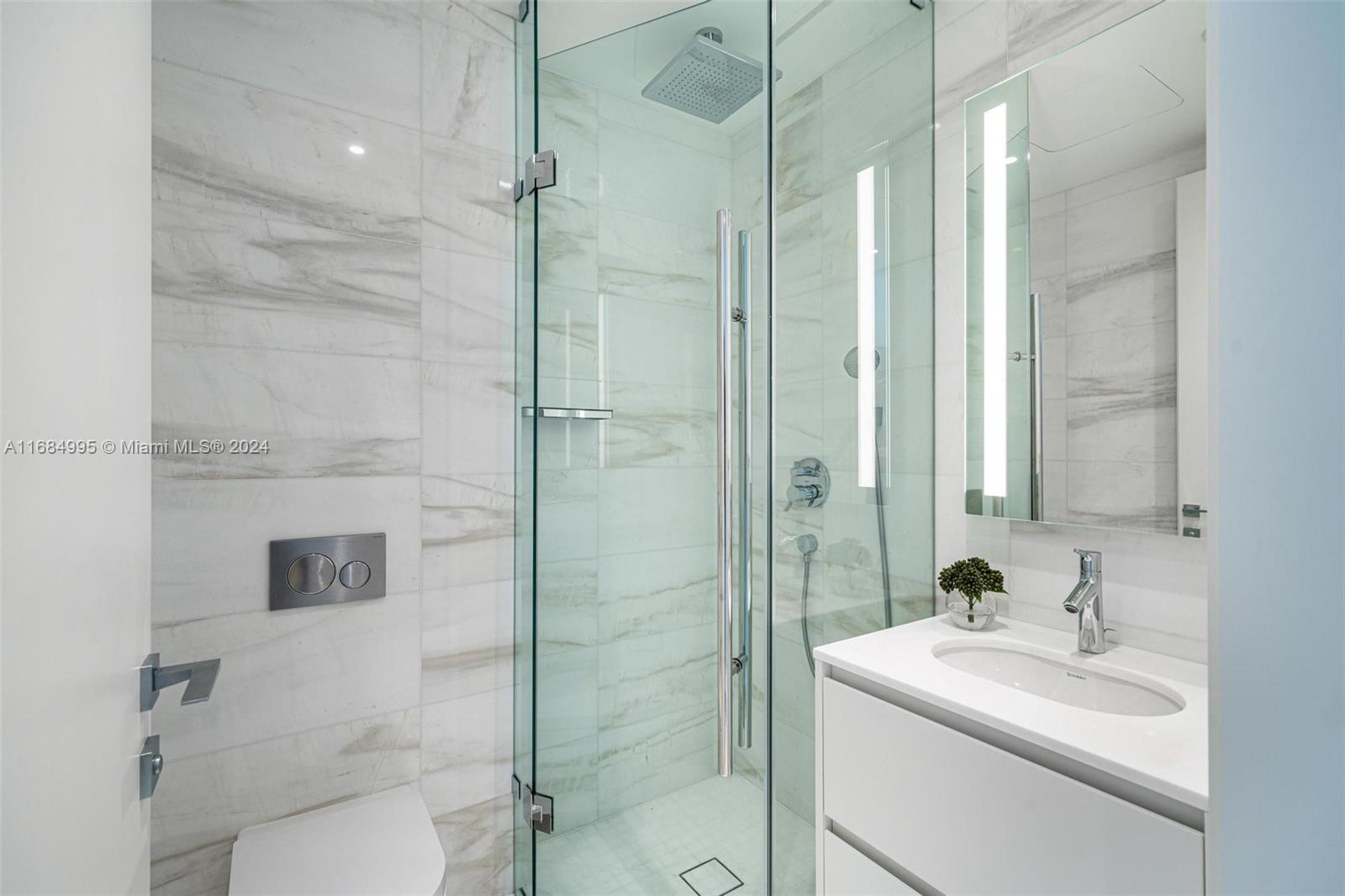 300 Biscayne Blvd Way, Unit 701 Miami, FL 33131 - Photo 24 of 37 a bathroom with a sink toilet and shower