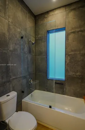 a bathroom with a toilet and a bathtub